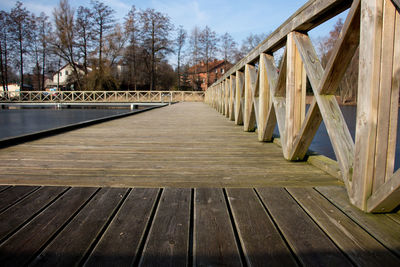 Close-up of wooden footbridge against sky