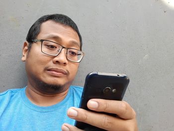 Portrait of young man using mobile phone