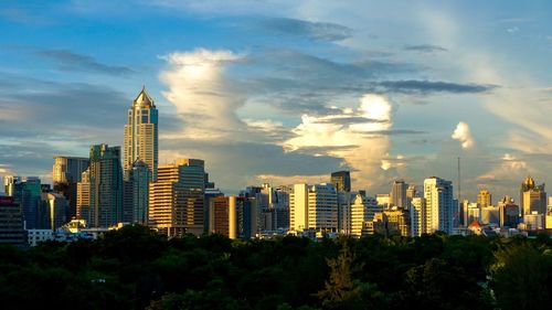 Skyscrapers against cloudy sky
