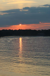 Scenic view of lake against romantic sky at sunset