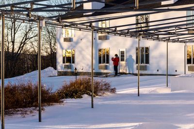 Full length of man standing by house during winter