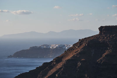 Scenic view of sea and mountains against sky