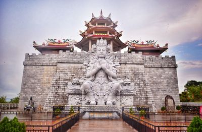 Statue of temple against building