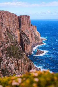 Rock formations by sea against sky