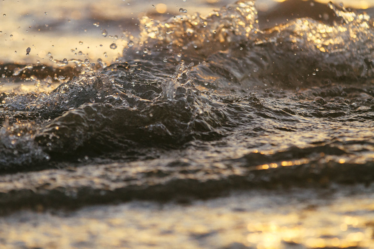 CLOSE-UP OF WATER DROP ON SEA SHORE