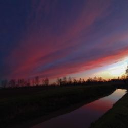 Scenic view of lake against romantic sky at sunset