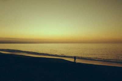 Scenic view of sea against clear sky at sunset