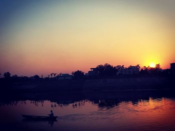 Scenic view of river against orange sky