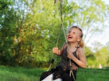 Portrait of young girl on swing