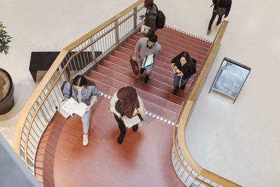 High angle view of students walking on steps in university