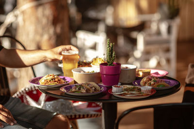 Midsection of person having food in restaurant