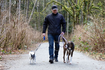 Full length of man with dog walking