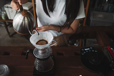 Barista dripping coffee and slow coffee wooden bar style