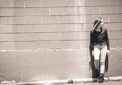 Full length of young woman standing outdoors