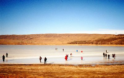 People on frozen lake, expired film