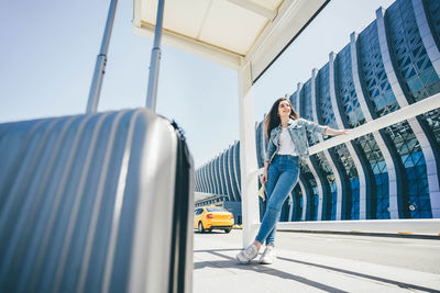 Low section of woman standing on railing