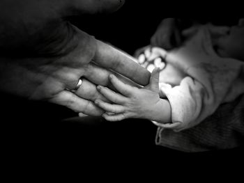 Midsection of couple holding hands