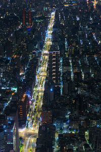 High angle view of illuminated city buildings at night
