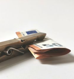 Close-up of piano on table against white background