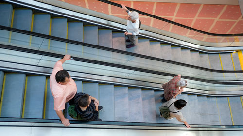 Full length of people dancing on railing