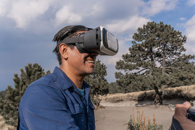 Side view of man wearing virtual reality headset