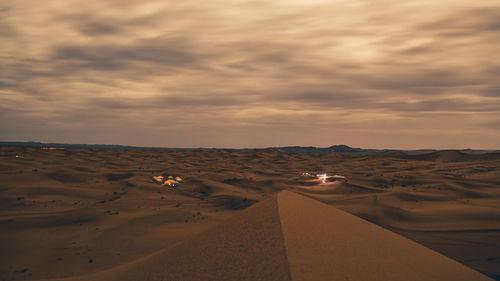 Scenic view of desert against sky during sunset