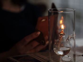 Close-up of illuminated tea light candle on table