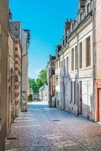 Empty alley amidst buildings in city