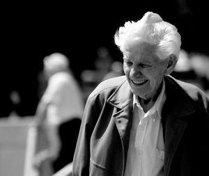 Smiling senior woman walking in city