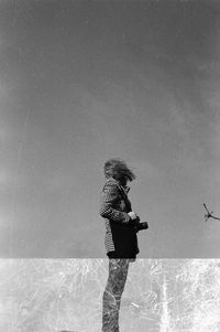 Reflection of woman and sky in pond