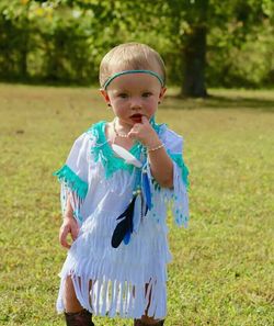 Portrait of cute girl on grassy field