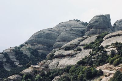 Low angle view of rock formations against sky