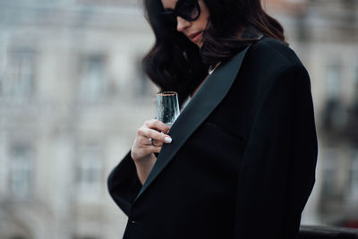 Midsection of a woman drinking glass