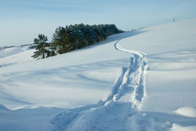 Scenic view of snow covered field against sky