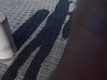 High angle view of shadow on footpath