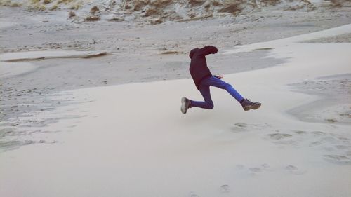 Full length of man jumping on beach