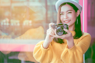 Portrait of woman photographing