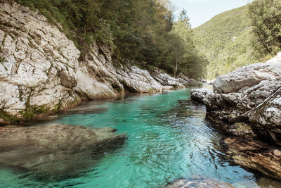 Scenic view of river amidst mountains against sky