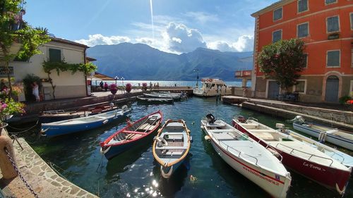 Panoramic view of boats moored at shore against sky