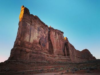 Low angle view of rock formation against clear sky