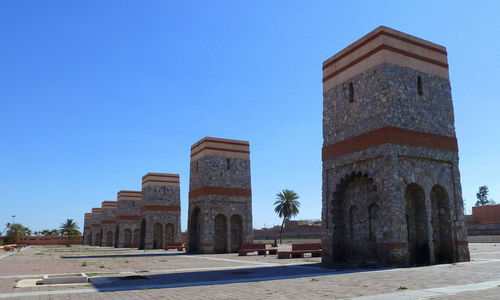 Historic buildings against clear blue sky