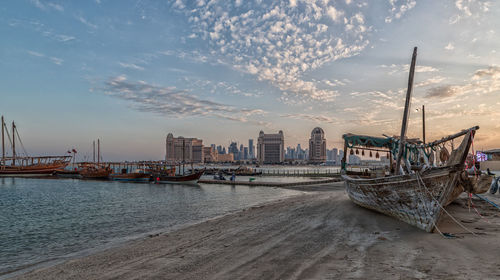 Scenic view of sea by buildings against sky