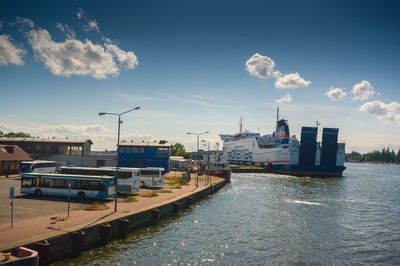 Scenic view of river against sky in city