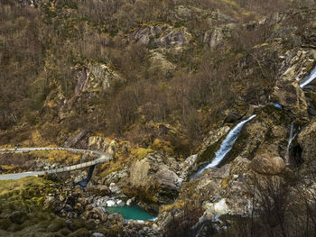 High angle view of river flowing by mountain