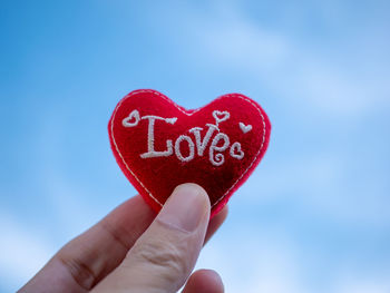 Close-up of hand holding heart shape with text