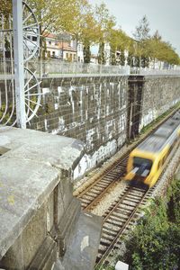 Train by trees against sky