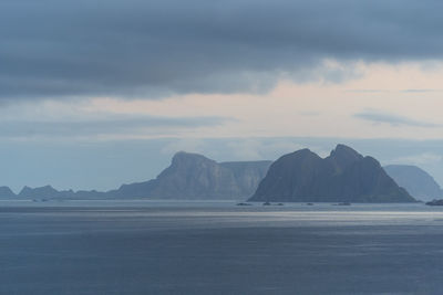 Scenic view of sea and mountains against sky