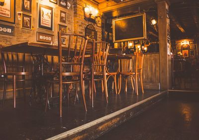Empty chairs and tables in restaurant