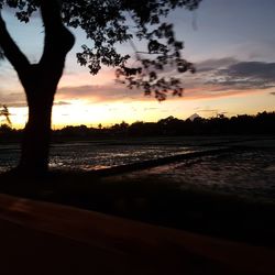 Scenic view of beach against sky during sunset