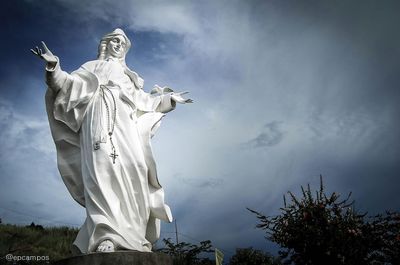 Low angle view of statue against cloudy sky